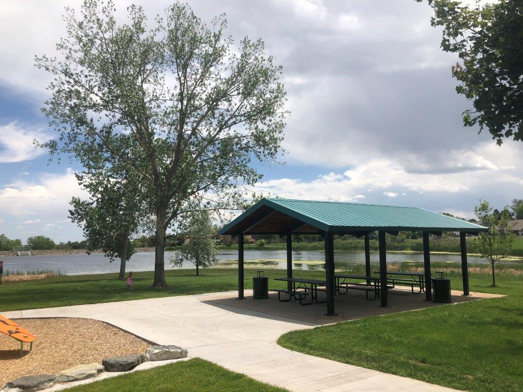 Beautiful picture of lake and large pavilion at Blue Heron Park