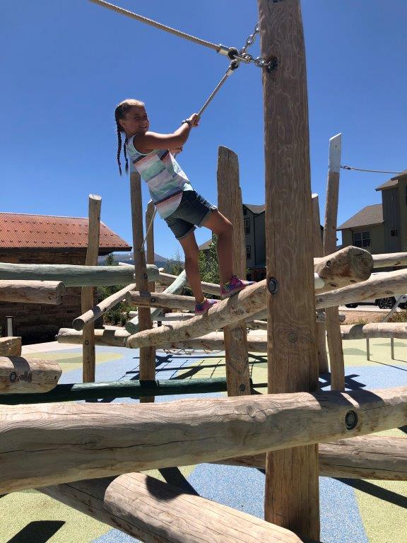 Girl on log play structure