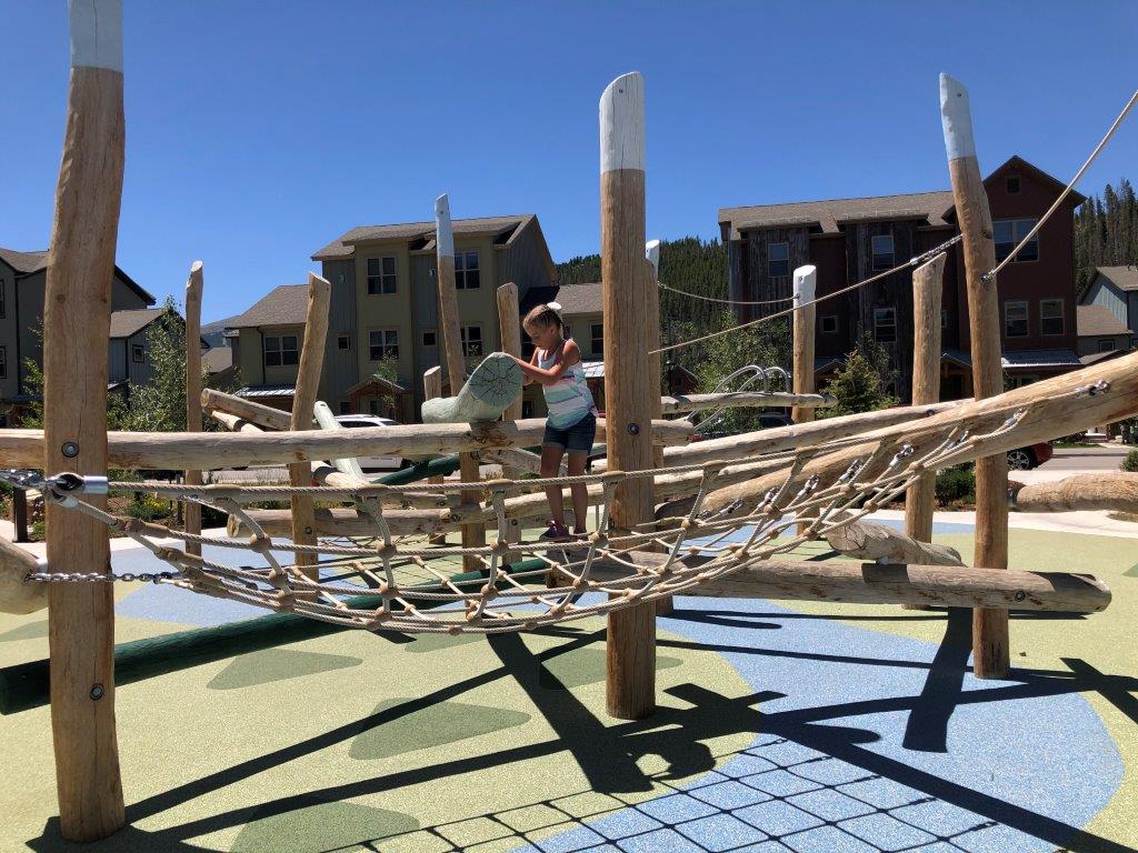 Log play structure at best playground in Breckenridge River Park