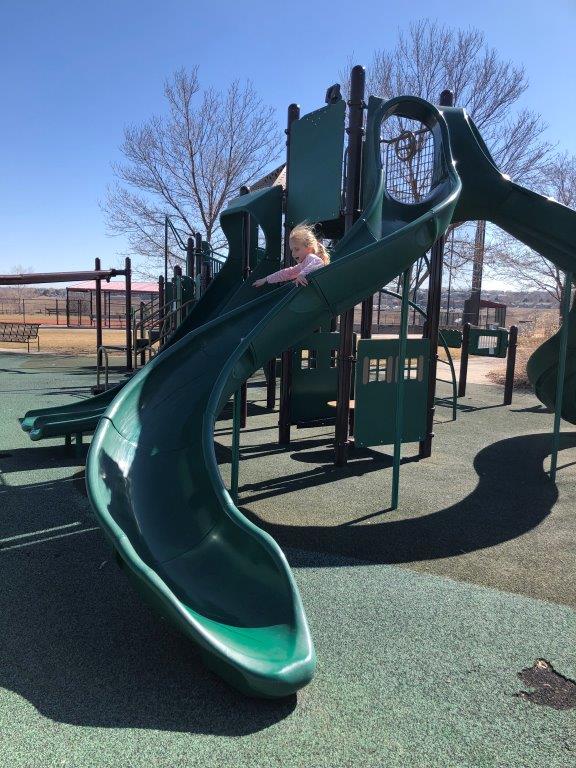 Girl coming down slide in Westminster parks