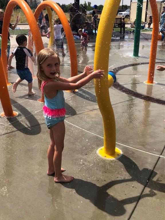Girl playing at Red-tailed Hawk splash park