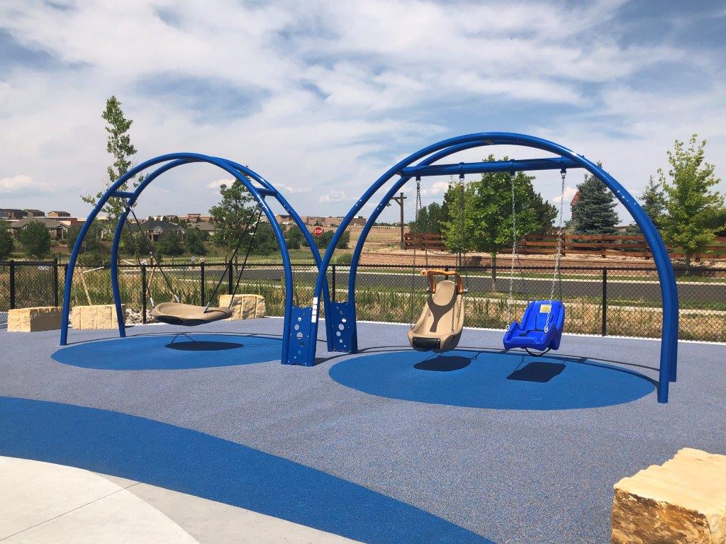 Disc and chair swings at inclusive playground in Aurora
