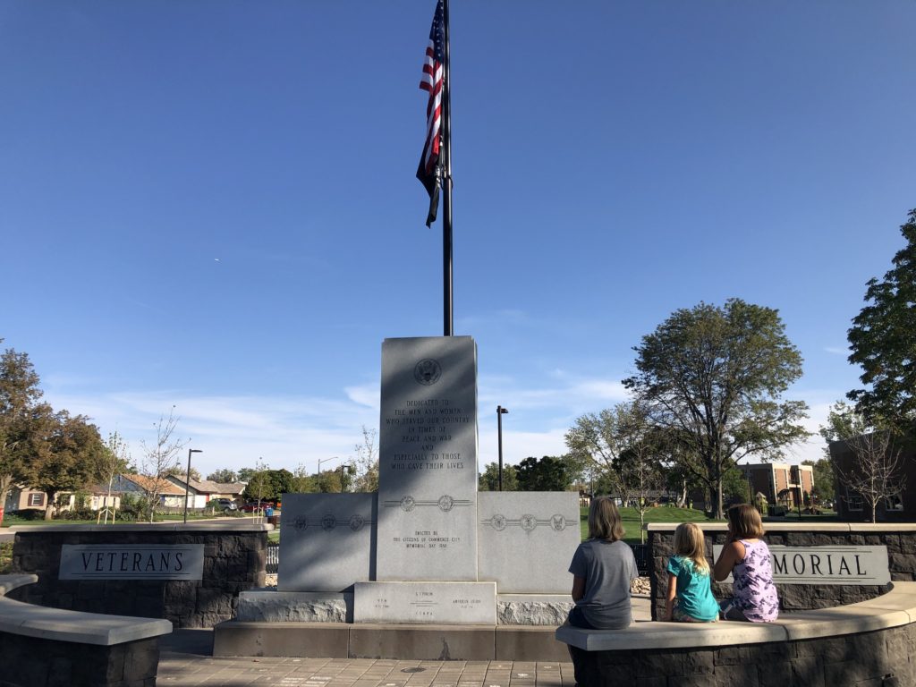 3 girls looking at Veterans Memorial in Commerce City
