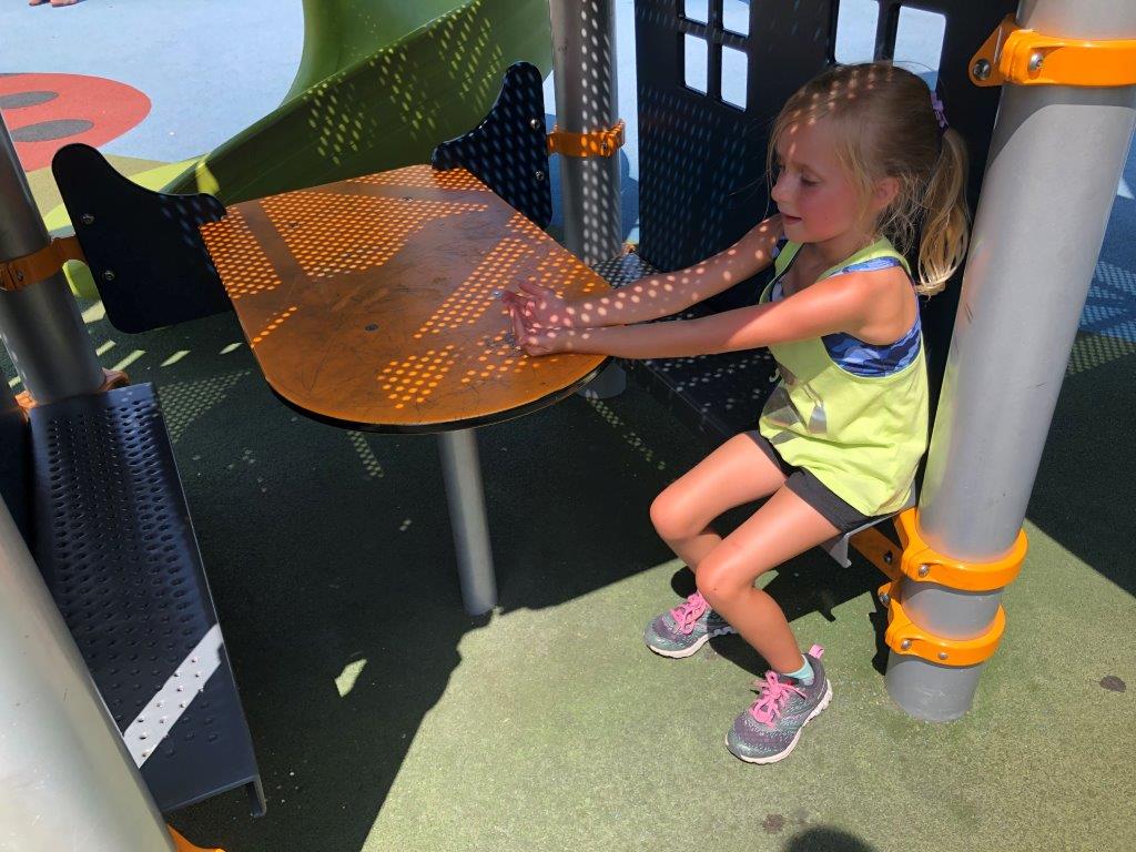 Girl sitting at playground table