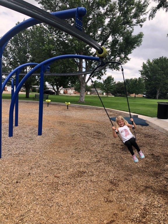 Girl on swing zipline at Westmoor Park in Greeley