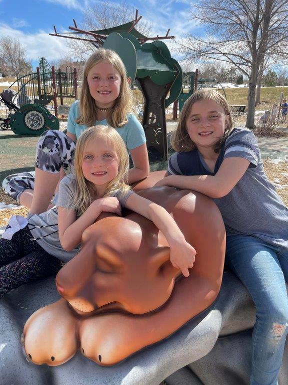 Three girls at cougar sculpture