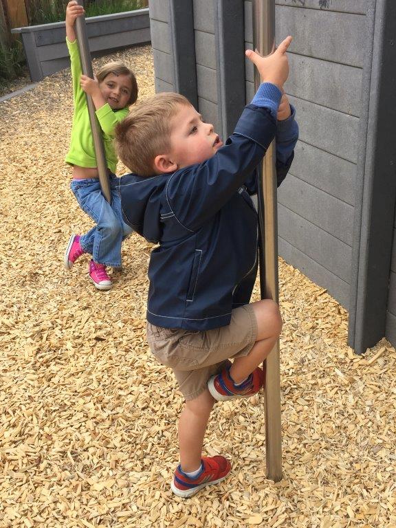 Kids on fireman poles