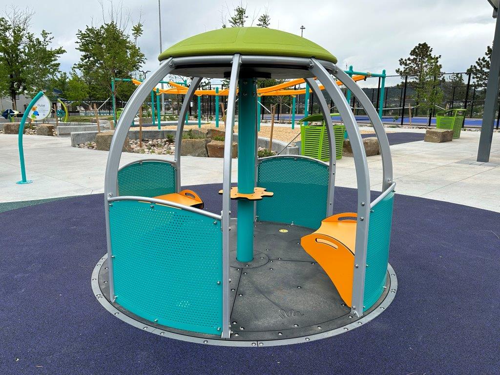 Possibilities Playground at Butterfield Crossing Park has a We Go Round, wheelchair accessible merry go round