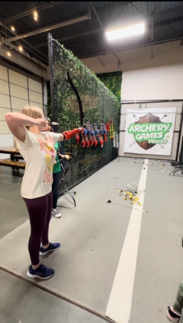 Girl shooting arrow at Denver Archery Games Archery Dodgeball