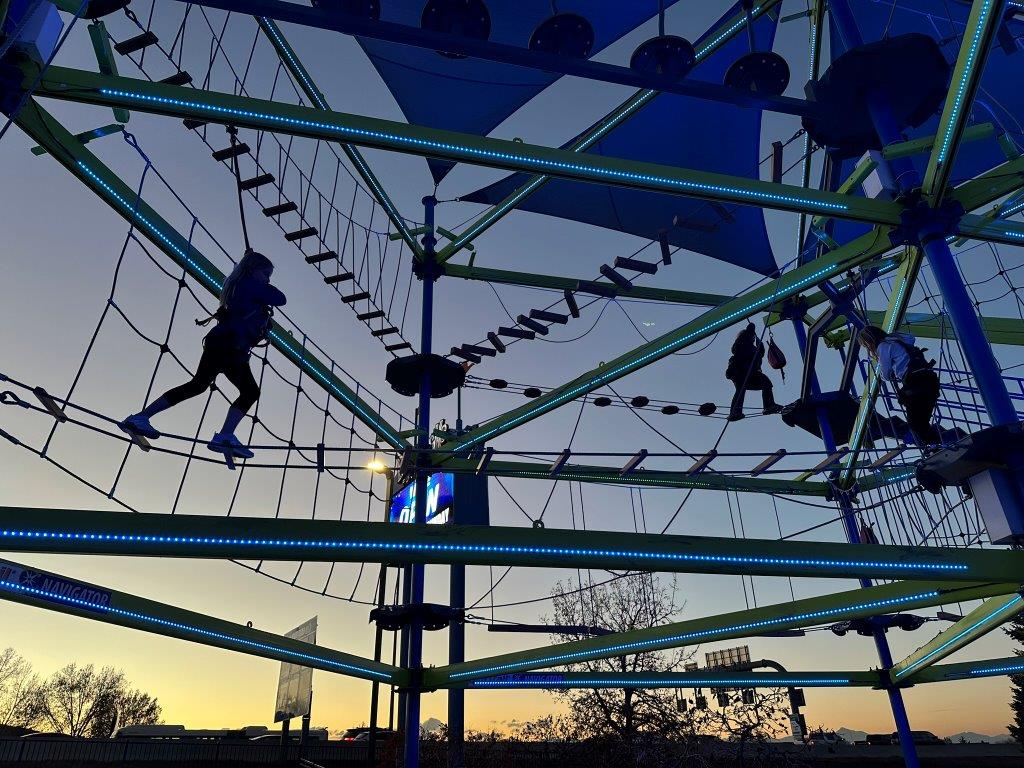 Kids going across Boondocks Northglenn ropes course at sunset