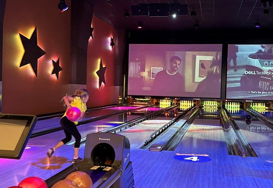 Girl bowling with bumpers at Boondocks Northglenn