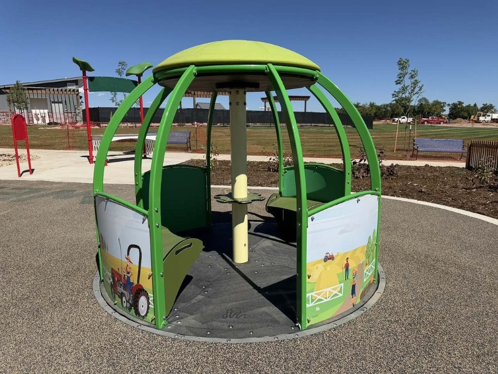 accessible merry go round at S'Miles Playground at Berthoud Adaptive Park Project